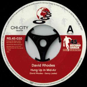 David Rhodes - Hung Up In Mid-Air - 7" Vinyl. This is a product listing from Released Records Leeds, specialists in new, rare & preloved vinyl records.